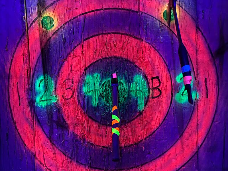 neon axes in a neon blacklight target